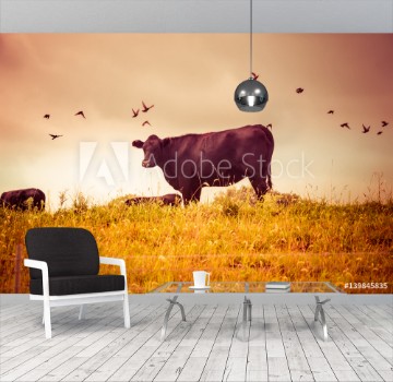 Bild på Cow grazing with birds vintage